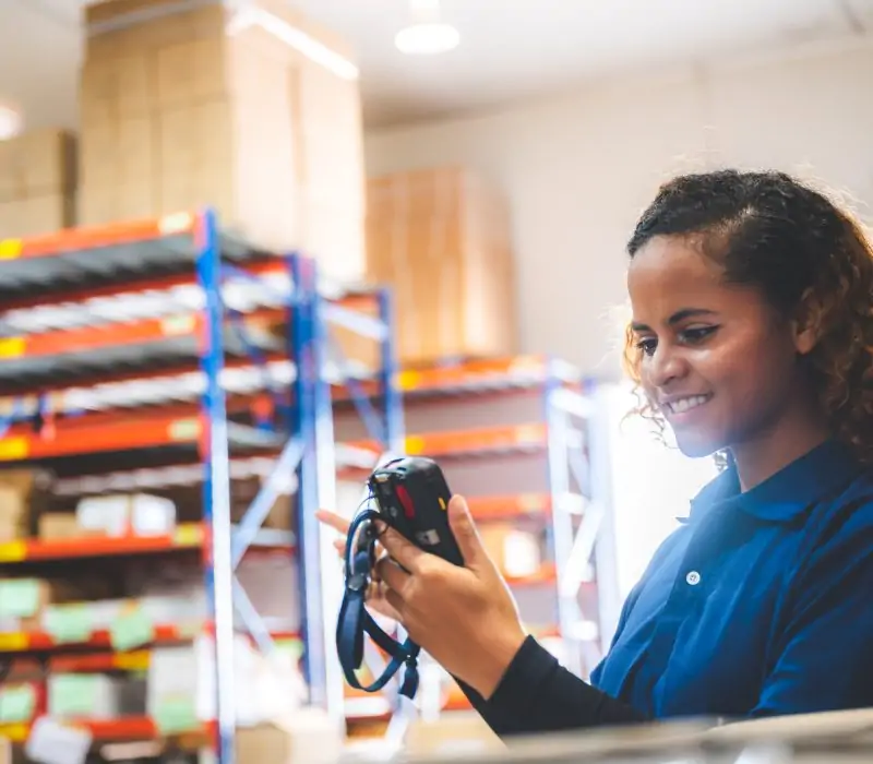 warehouse worker using bar code scanner to scanning box and analyze newly arrived goods for further placement in storage department, Working at warehouse.